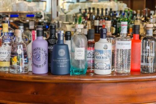 a bunch of bottles of alcohol sitting on a bar at Friars Wynd Guest Rooms in Stirling
