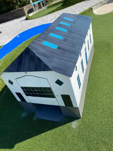 a house with a solar panel on the grass at Rønnes Hotel in Fjerritslev