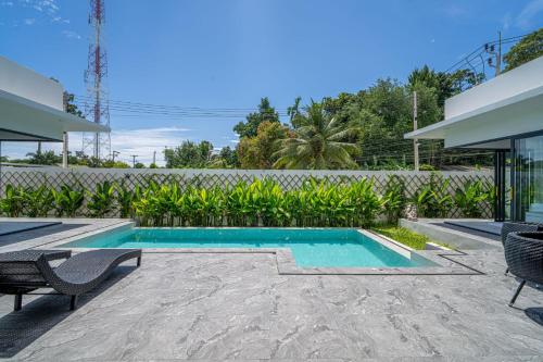 a swimming pool in the backyard of a house at Villa Chang - Fisherman Village Bophut in Bophut 