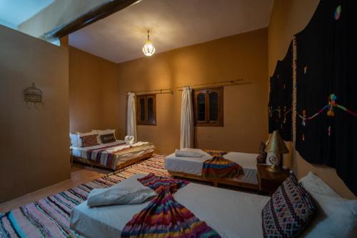 Ein Bett oder Betten in einem Zimmer der Unterkunft L'oasis Du Bonheur