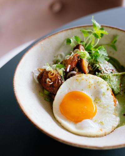a plate of food with an egg and vegetables at Hotel Rum Budapest in Budapest