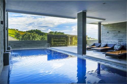 a swimming pool with blue water in a house at Daily Home Villa Dago in Bandung