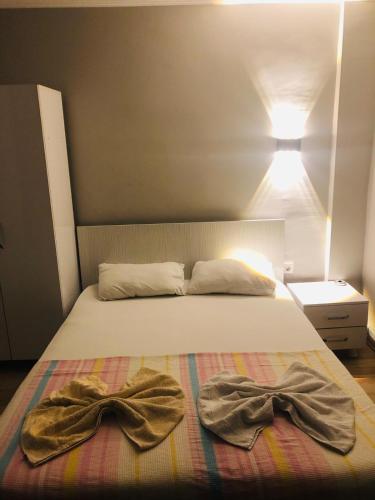 a bedroom with a bed with two towels on it at Gold in Confort hotel in Barbaros