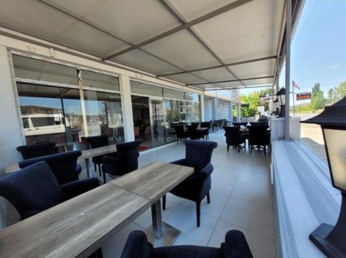 a restaurant with a wooden table and chairs at Gold in Confort hotel in Barbaros