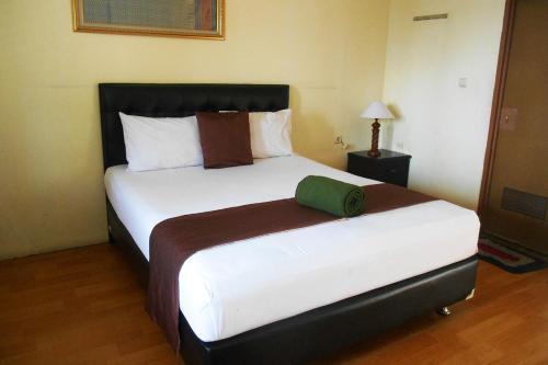 Postel nebo postele na pokoji v ubytování Cunang Hill Hotel & Resort