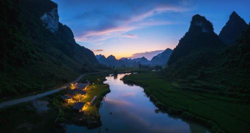 an aerial view of a river between two mountains at Phong Nam Station in Bản Piên