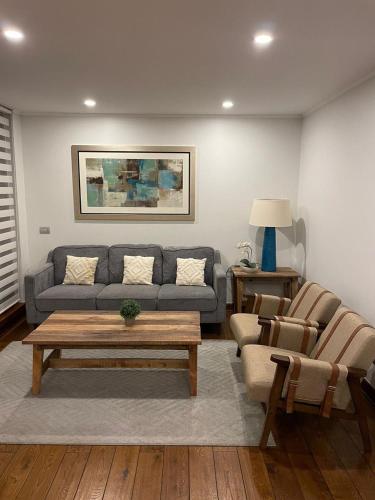 a living room with a couch and a coffee table at Lo Mejor de Pucón II in Pucón