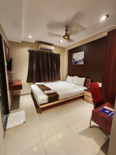 a bedroom with a large bed and a window at Hotel Saad in Kolkata