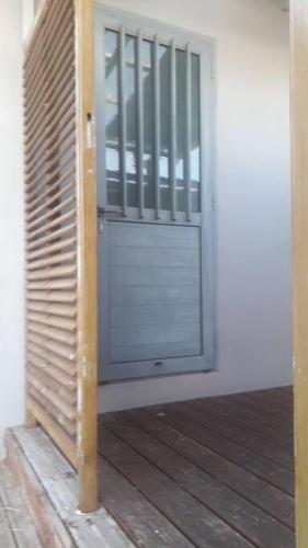 a door in a room with a wooden floor at CapNature in Saint-André