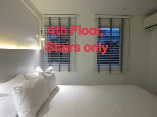 a bedroom with a bed and a window with the words air flow starts only at Urban house in Bangkok