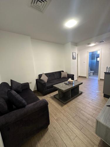 a living room with a couch and a coffee table at central apartment for rent 18 in Umm Uthainah