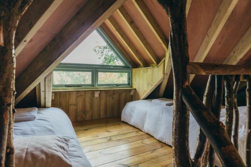 a room with two beds in a attic at West Lexham Retreat in Kings Lynn