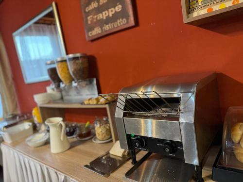 a toaster oven sitting on top of a kitchen counter at Hotel Formanka in Hustopeče