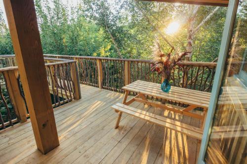 a wooden porch with a bench on a deck at West Lexham Retreat in Kings Lynn