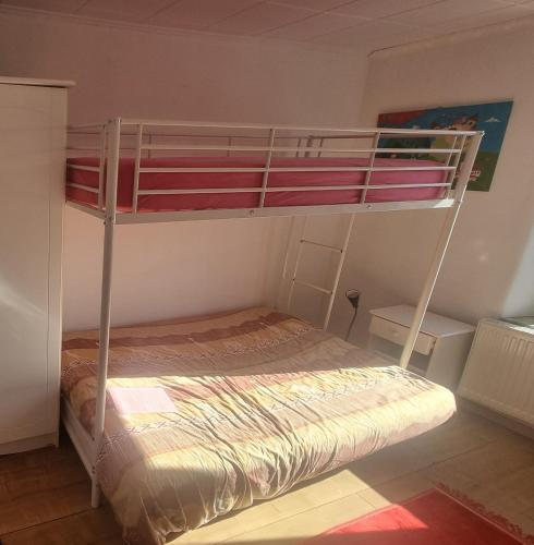 a bedroom with two bunk beds in a room at Relax Cozy Wellbeing Room Near train station in Kleinbettingen
