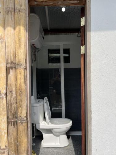 a bathroom with a toilet sitting inside of it at Lily Paradise in Siquijor