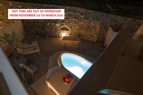 a sign that reads hot tubs are out of operation from nowhere list to market at LAGADI SUITES by K&K in Mesaria