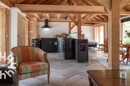a living room with a couch and a table at OV575 - Landelijk gelegen 2P vakantiehuis met hottub in Sint-Jansklooster in Sint Jansklooster
