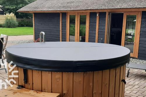 a hot tub in front of a gazebo at OV575 - Landelijk gelegen 2P vakantiehuis met hottub in Sint-Jansklooster in Sint Jansklooster