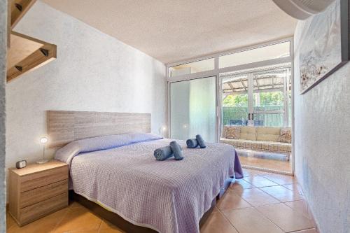 a bedroom with two beds and a large window at Lovely apartment in Callao Salvaje in Callao Salvaje