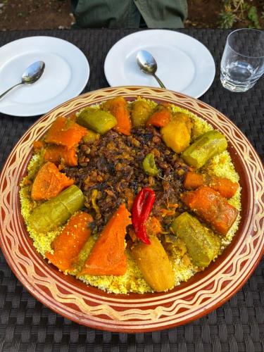 a bowl of food sitting on top of a table at Casa Indigo in Rabat