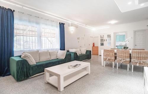 a living room with a green couch and a table at 2 Bedroom Lovely Home In Carratraca in Carratraca