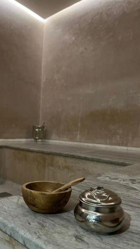 a bowl with a wooden spoon on a counter next to a tub at BUSINESS HOTEL SFAX in Sfax