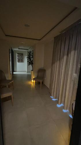 a living room with a chair and a window at BUSINESS HOTEL SFAX in Sfax