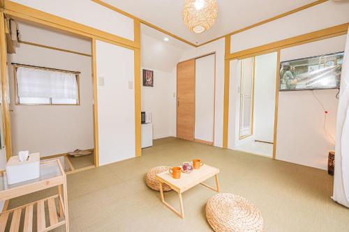 a living room with a table and a chair at sunrise 2 in Tokyo