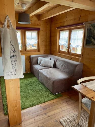a living room with a couch in a wooden house at Mazot JHR Unterbäch VS in Bachtolen