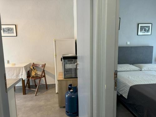 a bedroom with a bed and a table and a tableablish at MAREMA 2 in Kómpoi