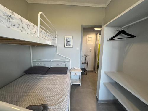 a small bedroom with a bunk bed and a staircase at MAREMA 2 in Kómpoi