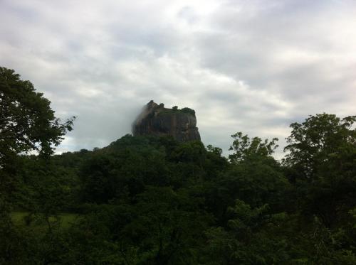 a rock formation in the middle of a forest at The Nature Park Villa in Sigiriya