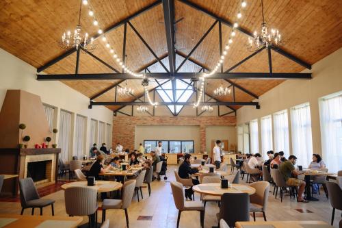 a group of people sitting at tables in a restaurant at Apricot Aghveran Resort in Agveran