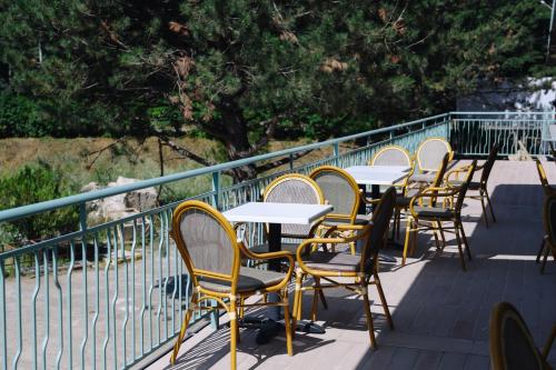 a row of tables and chairs on a balcony at Apricot Aghveran Resort in Agveran