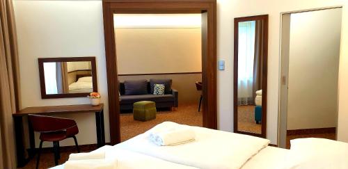 a hotel room with a bed and a mirror at Hotel Tennis Club in Prostějov