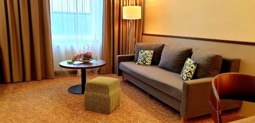a living room with a couch and a table at Hotel Tennis Club in Prostějov
