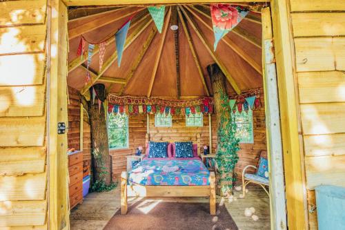 a bedroom in a log cabin with a bed in it at West Lexham Retreat in Kings Lynn