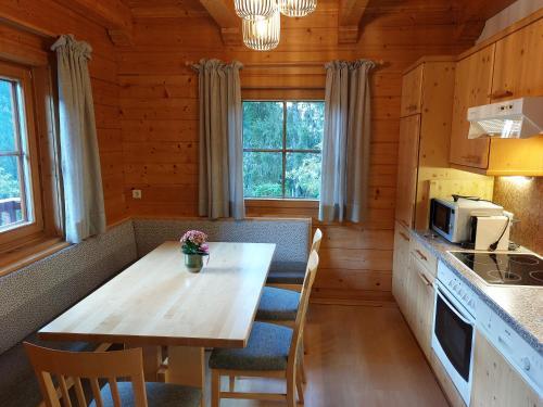 a kitchen with a table and chairs in a cabin at Landhaus Stiegler in Untertauern