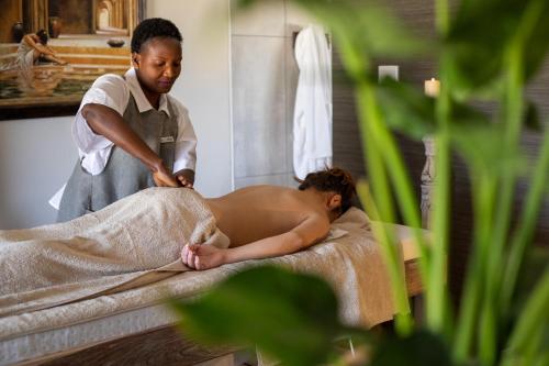 a woman in a spa getting a massage at Otjiwa Mountain Lodge in Otjiwarongo