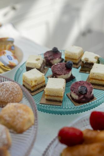 a bunch of different types of cakes and pastries on plates at Palazzo Martinelli in Sorrento