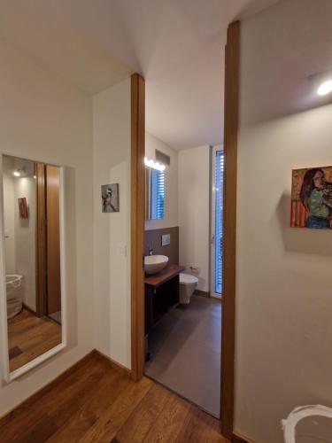a bathroom with a sink and a toilet and a mirror at Wonderful cozy apartment very well located in Gross Gurmels