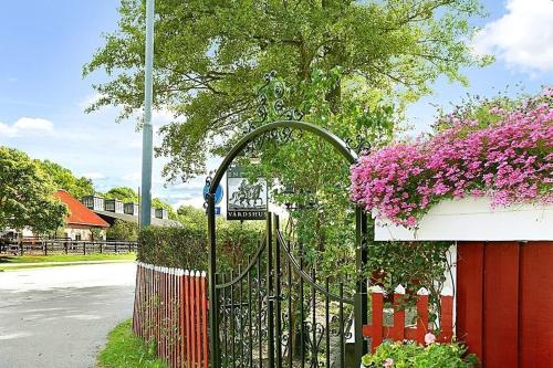 a black gate with purple flowers next to a building at Entire Apartment Stockholm in Stockholm
