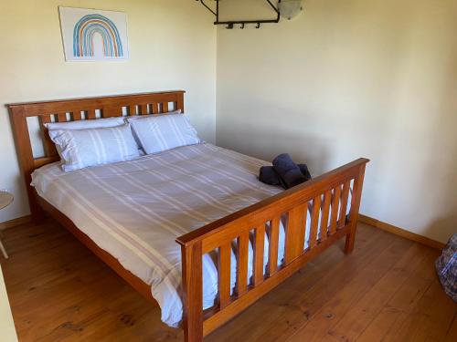a bedroom with a bed with a wooden frame at Classic Cabin in Langwarrin