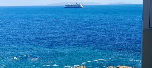 a large cruise ship in the middle of the ocean at Reis Magos Beach Caniço Sea line Apartment in Caniço