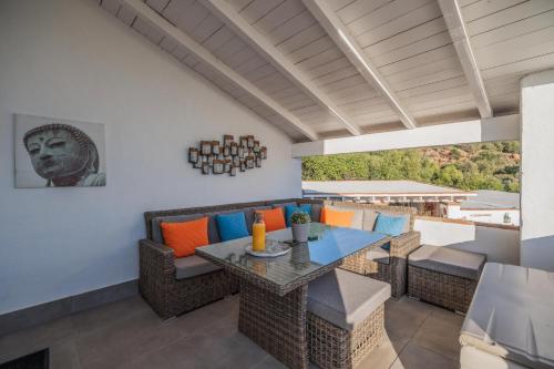 an outdoor patio with a table and chairs at Finca Gran Cerros in Alora