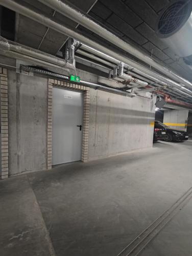 an empty parking garage with a white door at Apartament w Bartoszycach in Bartoszyce