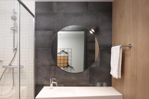 a bathroom with a sink and a mirror at Moxy Cork in Cork