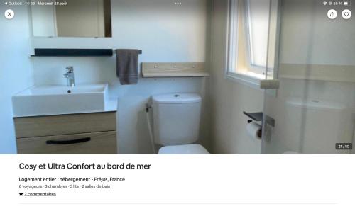 a bathroom with a white toilet and a sink at cosy et ultra confort au bord in Fréjus