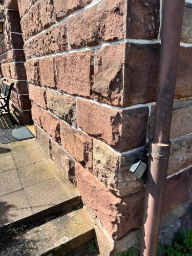 a brick wall with a pipe sticking out of it at Braustüberl in Alpirsbach